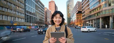 portrait-asian-girl-student-stands-city-centre-with-cars-busy-street-holds-digital-tablet_1258...jpg